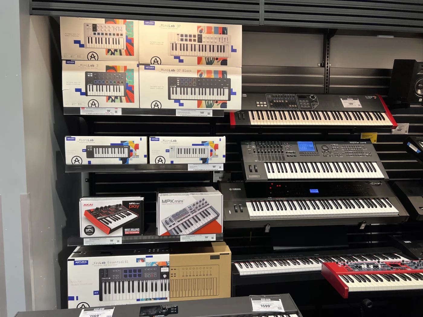 Arturia products organized on a Guitar Center keyboard wall after merchandising